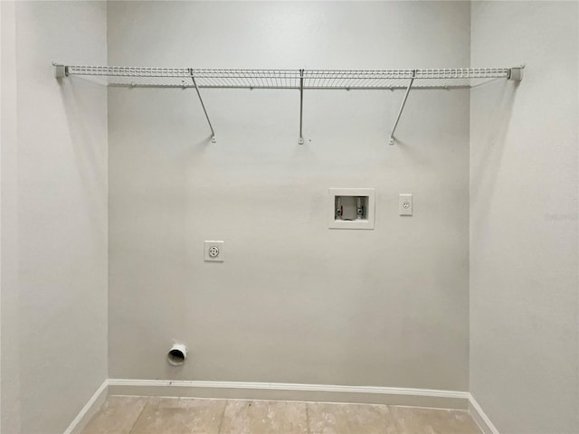 clothes washing area featuring laundry area, washer hookup, electric dryer hookup, and baseboards