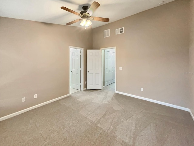 unfurnished bedroom featuring carpet flooring, visible vents, and baseboards