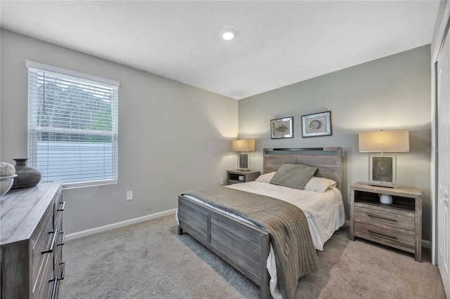 carpeted bedroom featuring baseboards