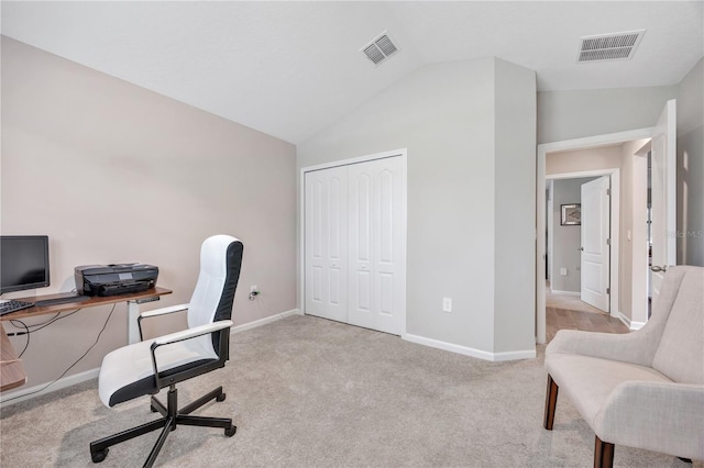 carpeted office featuring visible vents, lofted ceiling, and baseboards