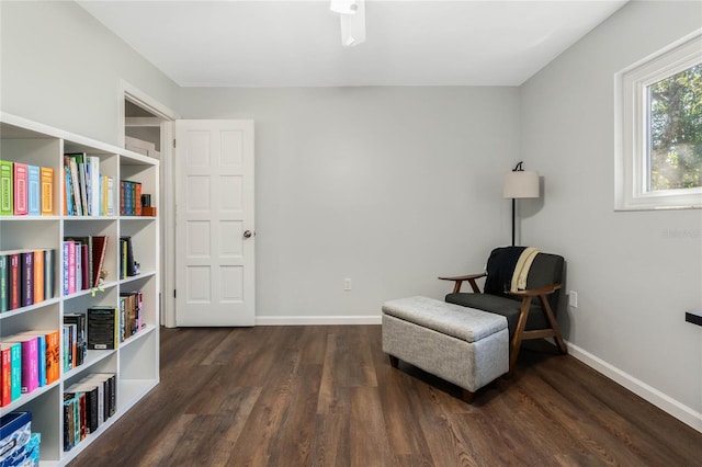 sitting room with baseboards and wood finished floors