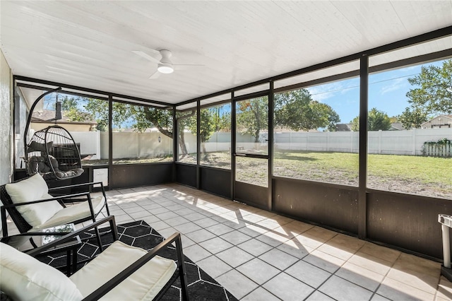 unfurnished sunroom with ceiling fan