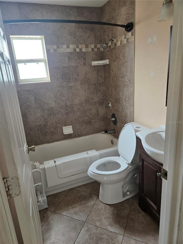 full bathroom featuring tile patterned flooring, bathing tub / shower combination, toilet, and vanity