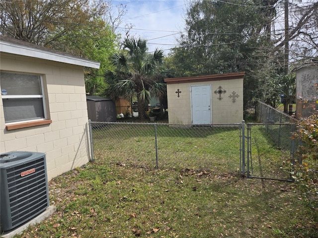 view of yard featuring a storage shed, an outbuilding, central air condition unit, and fence