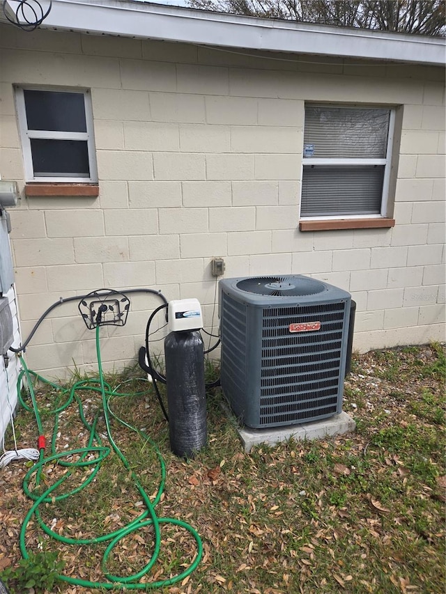 details featuring concrete block siding and central air condition unit