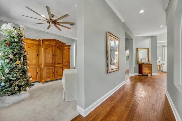 hall with ornamental molding, recessed lighting, light wood-style floors, and baseboards