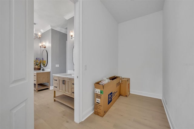 bathroom with baseboards, a chandelier, wood finished floors, and vanity