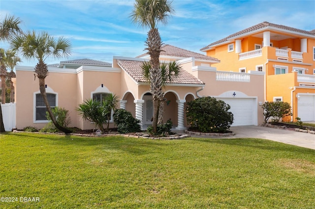 view of front of property featuring concrete driveway, a front yard, and stucco siding