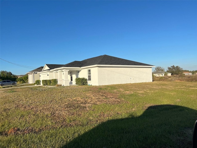 view of property exterior featuring a lawn and stucco siding