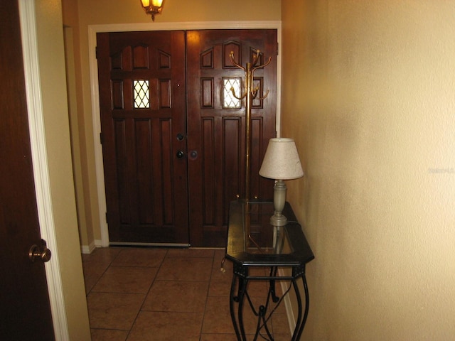 tiled entrance foyer with baseboards