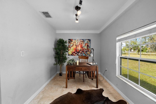 office area with a wealth of natural light, visible vents, baseboards, and light tile patterned floors