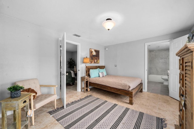 bedroom with tile patterned floors, visible vents, and ensuite bathroom