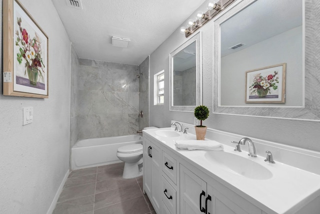 bathroom featuring visible vents, a textured ceiling, toilet, and a sink