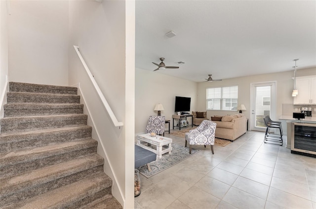 stairway featuring tile patterned flooring, beverage cooler, visible vents, and ceiling fan