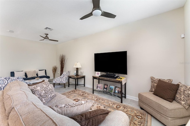 tiled living room with ceiling fan, visible vents, and baseboards