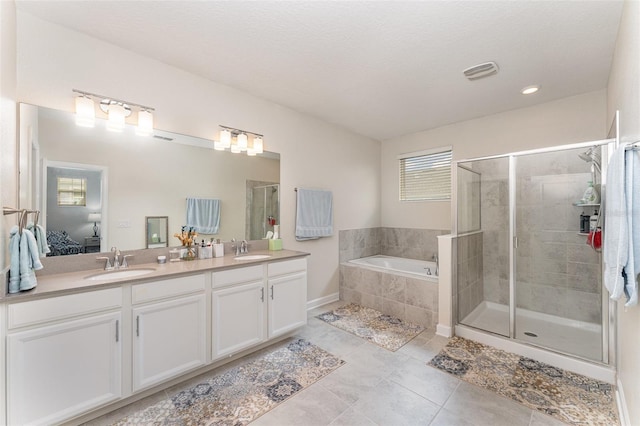 full bath featuring double vanity, a stall shower, a sink, and visible vents