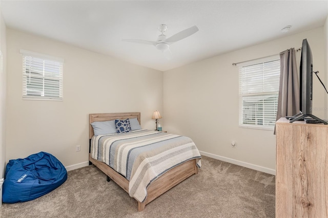 carpeted bedroom featuring a ceiling fan and baseboards