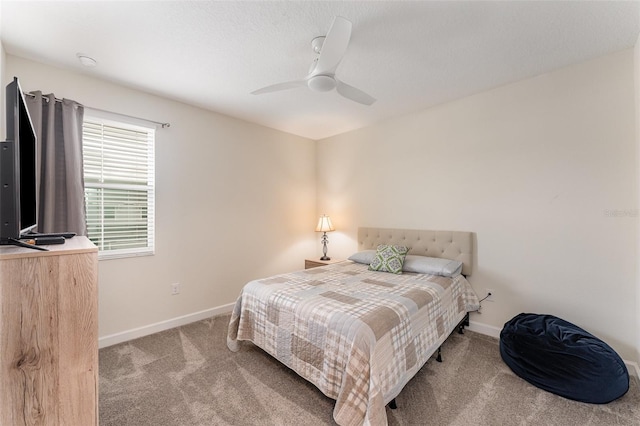 bedroom featuring carpet floors, a ceiling fan, and baseboards