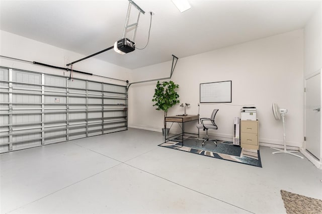 garage with baseboards and a garage door opener