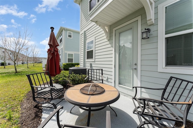 view of patio with a fire pit and central AC unit