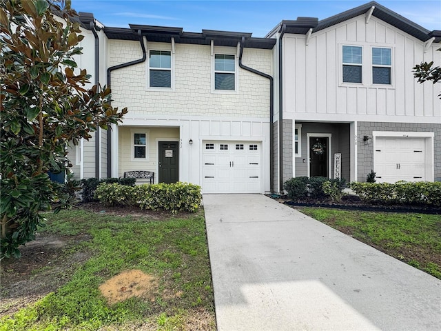 view of property featuring an attached garage, board and batten siding, and concrete driveway