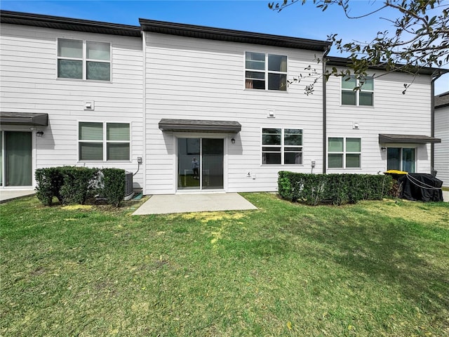 rear view of property with a patio and a yard