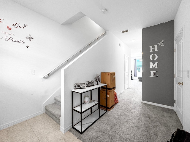 stairs featuring carpet floors, baseboards, and visible vents