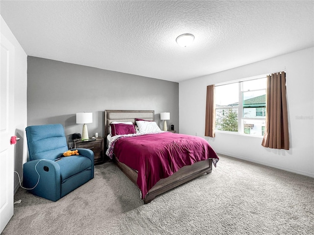 bedroom featuring a textured ceiling, baseboards, and carpet flooring