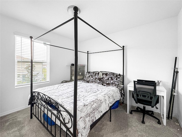 carpeted bedroom featuring baseboards