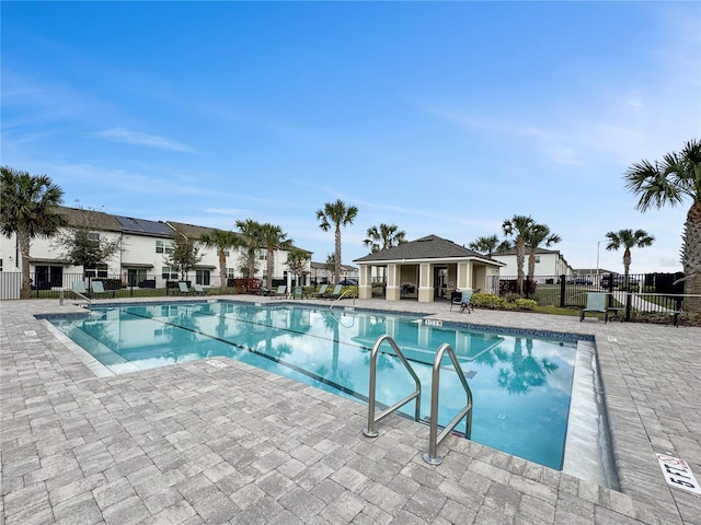 pool featuring a patio and fence