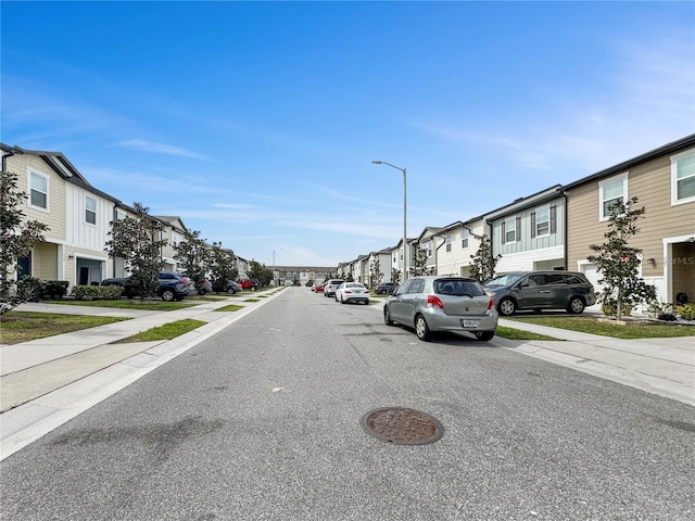 view of street featuring sidewalks, street lighting, and a residential view