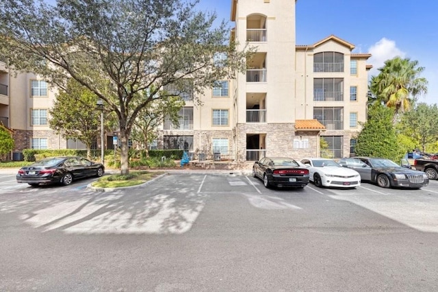 view of building exterior with uncovered parking