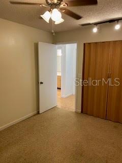 unfurnished bedroom featuring carpet floors and a textured ceiling