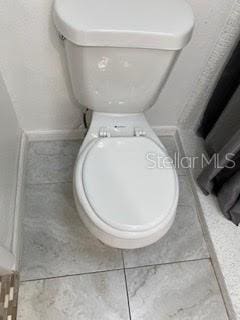 bathroom with tile patterned flooring and toilet