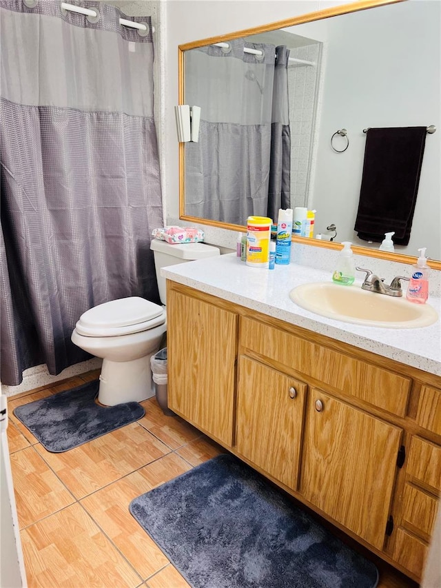 bathroom with toilet, curtained shower, and vanity