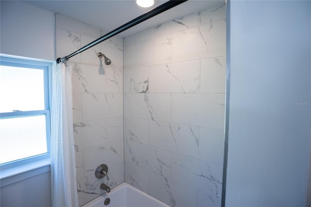 full bath featuring a healthy amount of sunlight and shower / bathtub combination with curtain