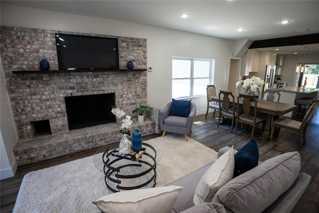 living area with recessed lighting, a fireplace, wood finished floors, and a healthy amount of sunlight