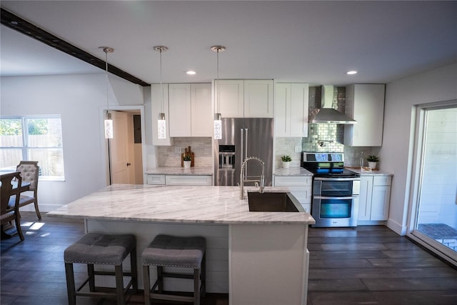 kitchen with wall chimney range hood, white cabinetry, dark wood-style floors, and appliances with stainless steel finishes