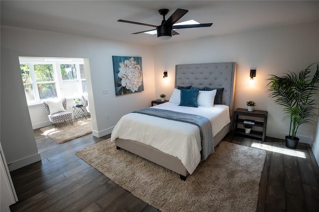 bedroom with a ceiling fan, baseboards, and wood finished floors