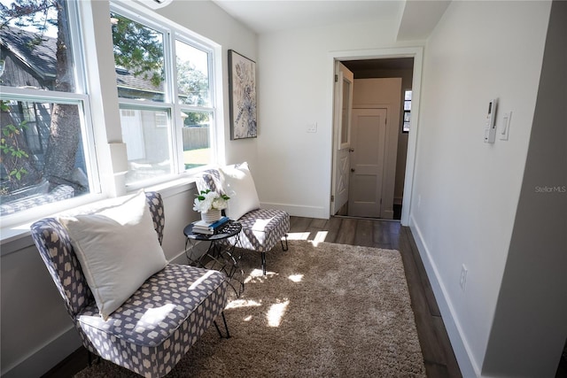 interior space with baseboards and wood finished floors