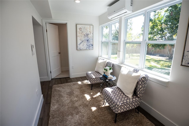 sitting room with recessed lighting, baseboards, wood finished floors, and a wall mounted AC