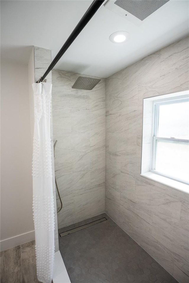 bathroom featuring visible vents and tiled shower