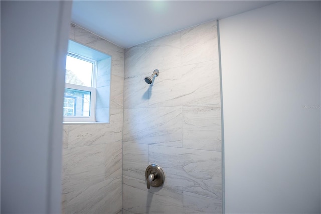 bathroom with a tile shower