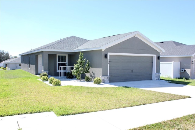 single story home featuring an attached garage, concrete driveway, roof with shingles, stucco siding, and a front yard