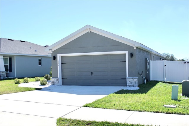 view of front of home featuring stucco siding, concrete driveway, a gate, fence, and a front lawn