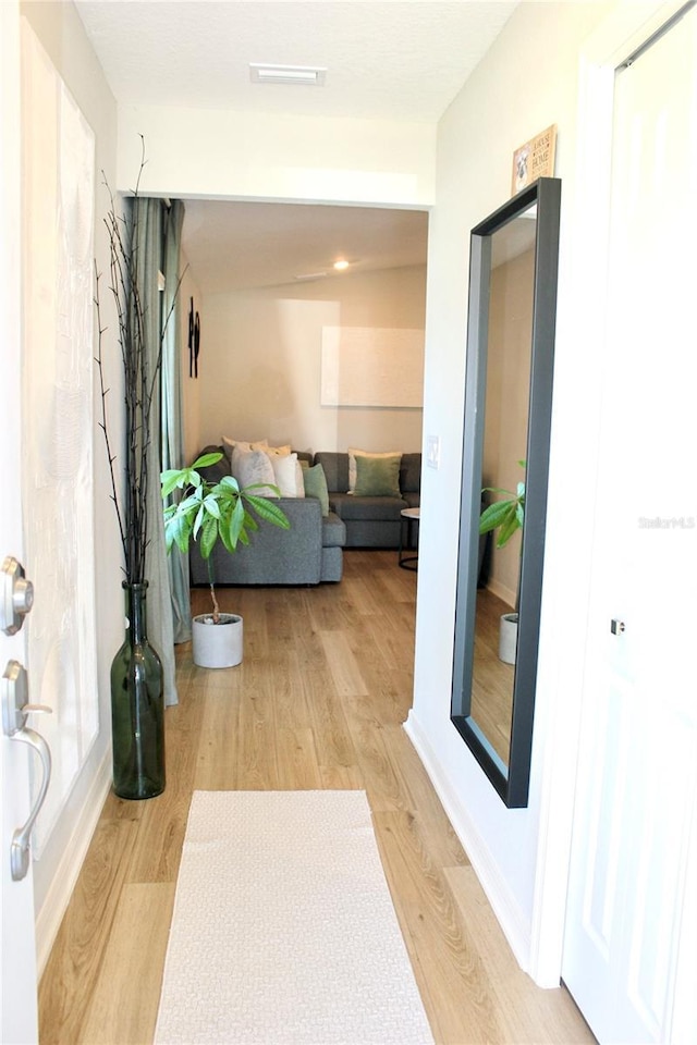 corridor featuring light wood finished floors