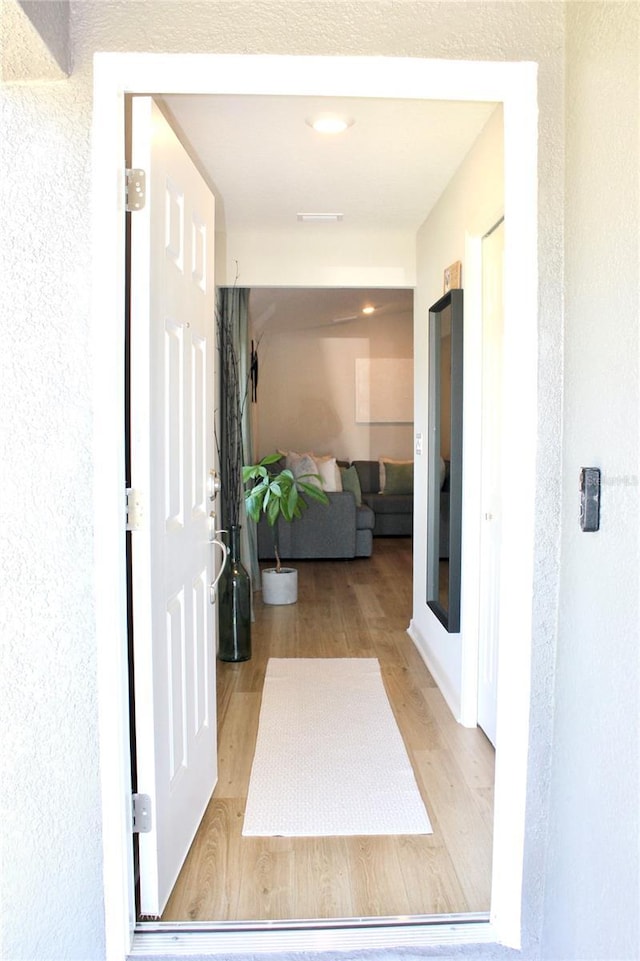 hall with wood finished floors