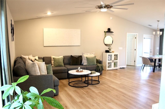 living room with lofted ceiling, ceiling fan with notable chandelier, baseboards, and light wood-style floors