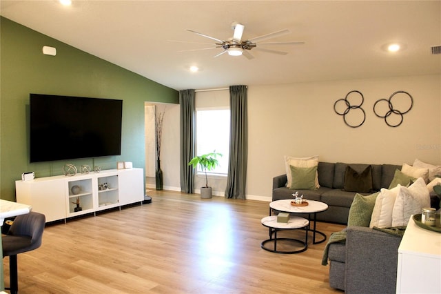 living room with baseboards, visible vents, a ceiling fan, lofted ceiling, and light wood-style floors