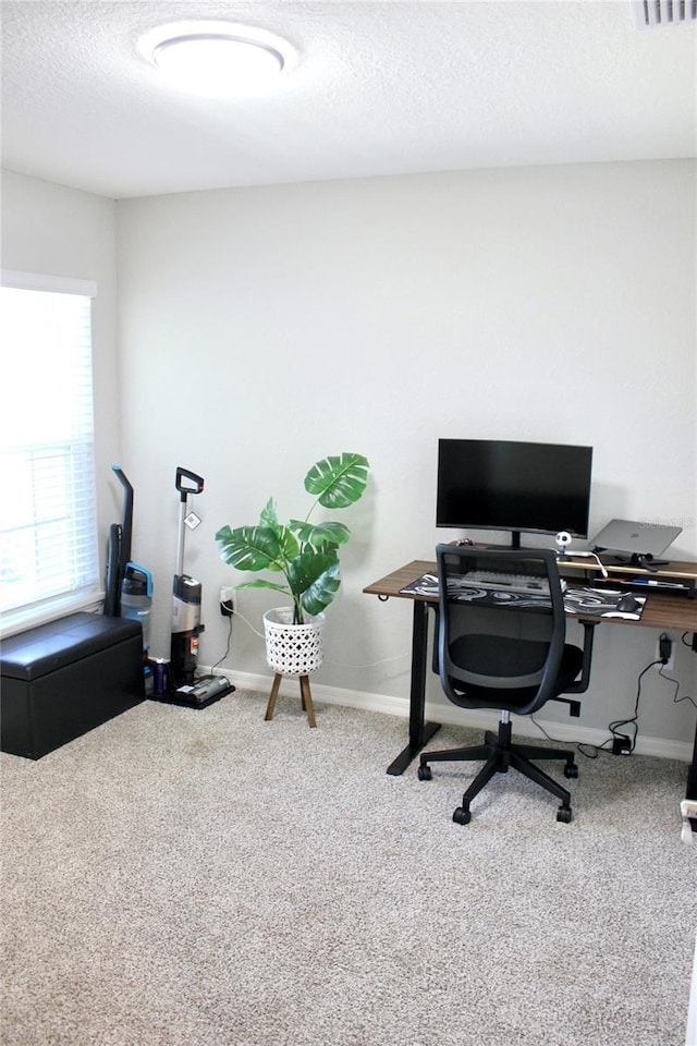 office space with carpet, baseboards, and a textured ceiling